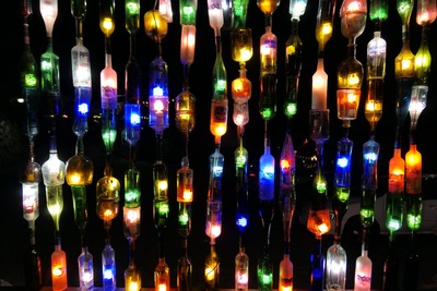 Wall of illuminated bottles at night