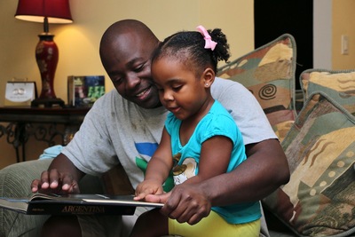 Father and daughter reading together